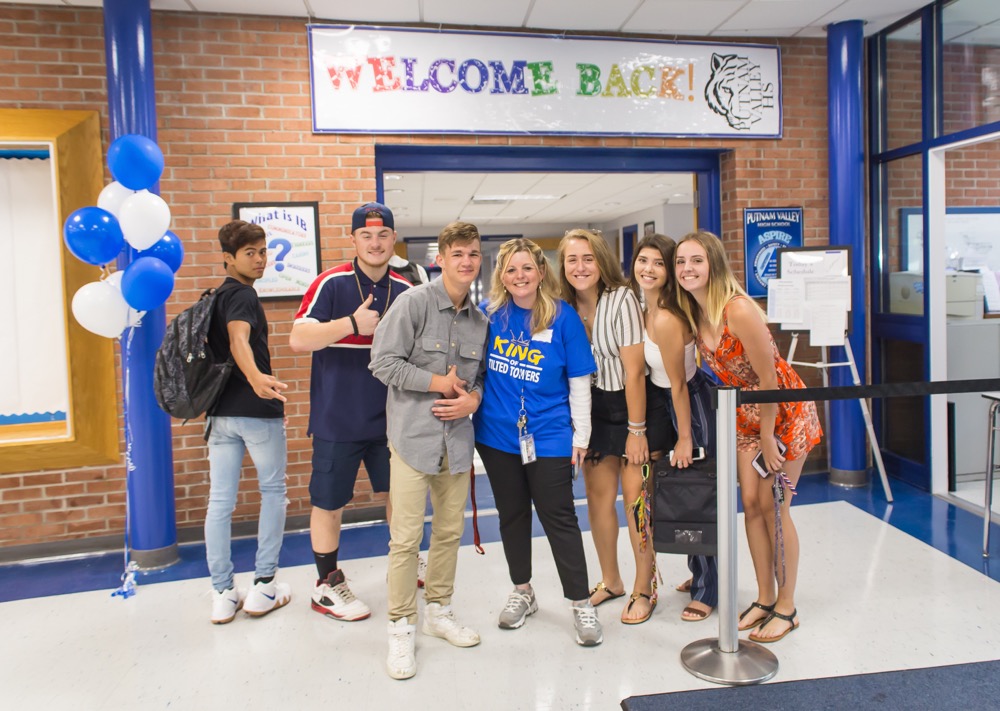 Students pictured with Ms. Intrieri on first days of school